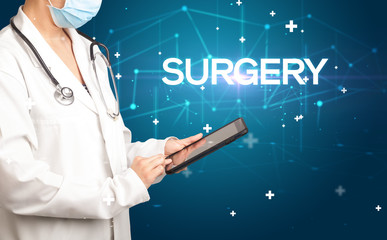 Doctor fills out medical record with SURGERY inscription, medical concept