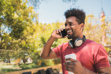 Young afro man talking on the phone.