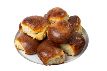 Sweet buns on a dish. Baked hot homemade buns. Isolated on a white background