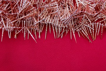 Merry Christmas and happy new year decorations for the Christmas tree in the shape of shiny icicles. Christmas toys on a red background. Set of brilliant holiday decorations.