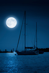 A beautiful midnight moonrise over a peaceful harbor on a warm summer night is the ultimate scenery when traveling the coast. This photo illustration best depicts the feeling.
