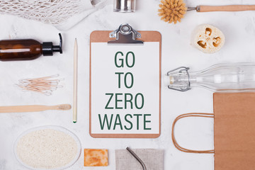 Natural bath and kitchen accessories on white background and text Go To Zero Waste.