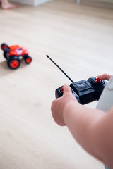 child plays with a remote control car 