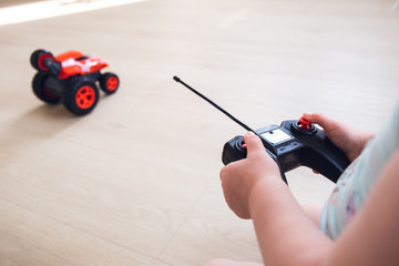 child plays with a remote control car 