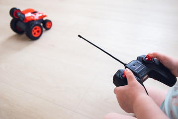 child plays with a remote control car 