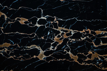 Obraz na płótnie Canvas black marble slab with yellow streaks for facing, landscape, interior.