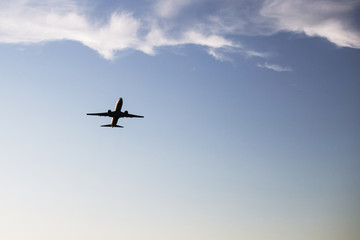 Airplane on a background of blue sky. The plane is landing. The plane takes off.