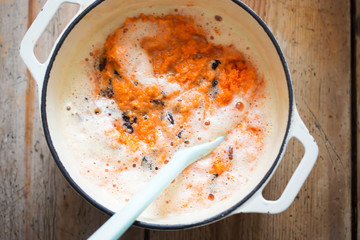 Carrot cake batter with beaten eggs, grated carrots & raisins