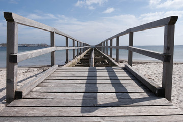 Fototapeta na wymiar disassembled wooden pier on the European sea