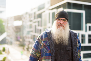 Mature bearded hipster man in the city streets outdoors