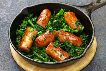 salsiccia e cime di rapa, sausage and braised tunip greens in skillet, southern italian cuisine