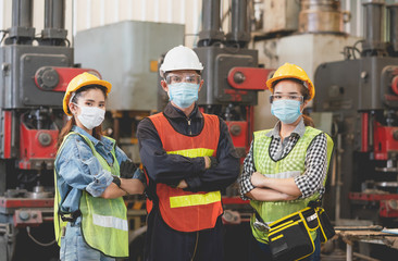 Group of Asian male and female engineers wearing hygienic mask protect with helmet safety in...