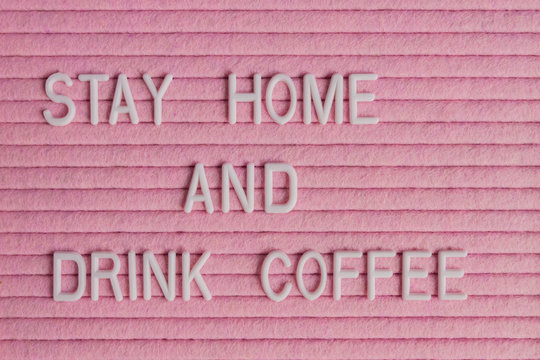 Quote stay home amd drink coffee on pink background. Work at home during coronavirus pandemia. freelance