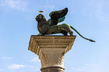 The figure of a winged lion on top of a pillar in Piazza San Marco in Venice, Italy
