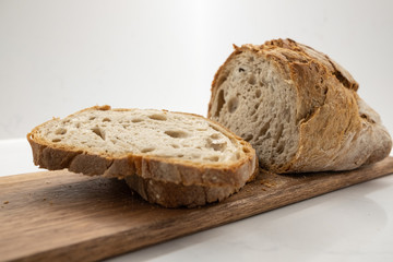freshly cut homemade bread on a wooden board.
