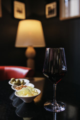 Glass of wine in restaurnt witth snacks