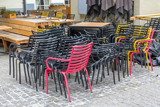 Stacked Metal Chairs in Front of Restaurant