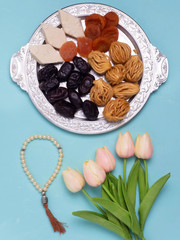 Flatley with rosaries, sweets, dates and tulips. The Concept Of Ramadan.
