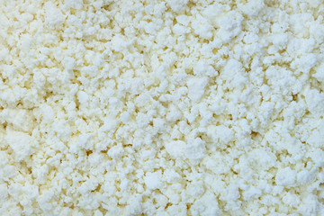 A close-up of fresh village cottage cheese as a background. Horizontal orientation, selective focus.