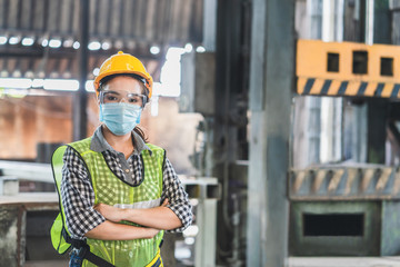 Asian female engineers wearing hygienic mask protect with helmet safety in factory Industrial.Coronavirus Protective, safety concept
