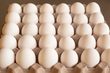 Fresh organic white eggs on the kitchen table - egg carton