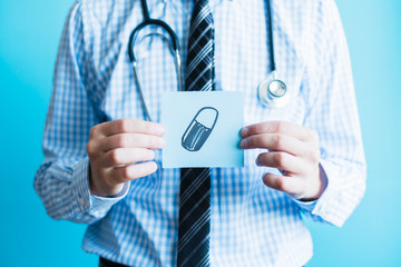 Doctor holding a pill