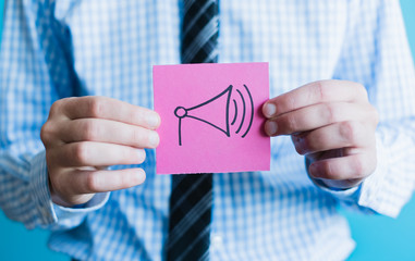 Hand holding a megaphone.