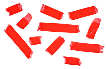 Set of red tape slices isolated on white background. Red insulating tape of different shapes.
