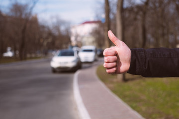 Hitchhiking youngster quite desperate to get a lift