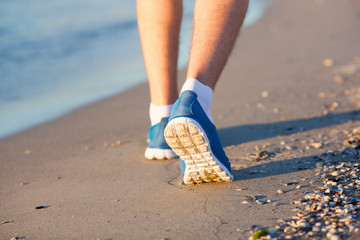 Athlete running in the sand feet