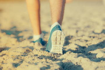Athlete running in the sand feet