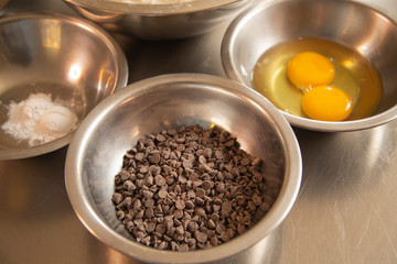 Ingredients for making chocolate chip cookies - chocolate chips and eggs in bowl