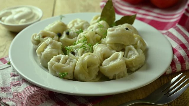 dumplings lie on a plate and sprinkled with dill on top
