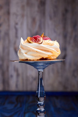 Close up of dessert Pavlova with raspberries and figs