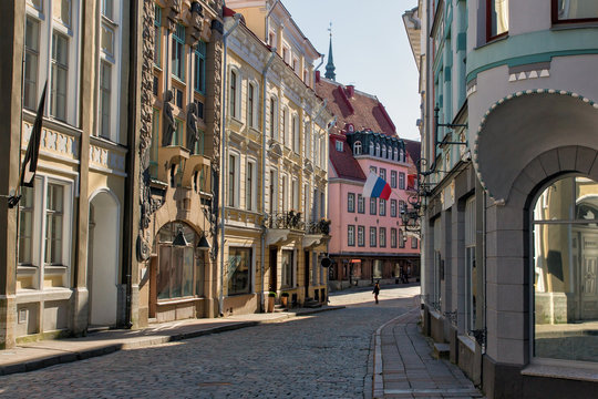 beautiful and picturesque Long street (Pikk) in the city of old Tallinn. Architectural facade. Medieval architecture of Estonia. Colorful buildings. Spring season in Europe.
