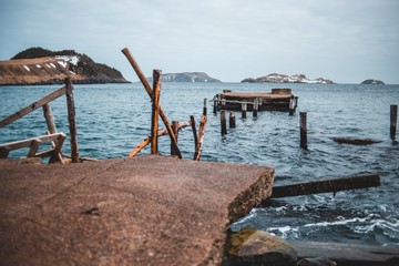 broken concrete dock in newfoundland next to ocean