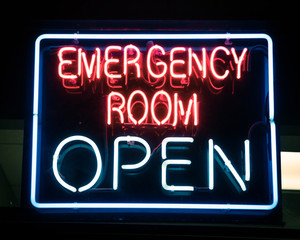 Open neon or led sign of an emergency room illuminated at night in America