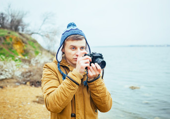 Man photographs on film camera