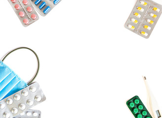 Lots of packs of pills and medical mask on white