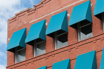Blue awnings on brick building
