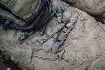 Close up of muddy work boots