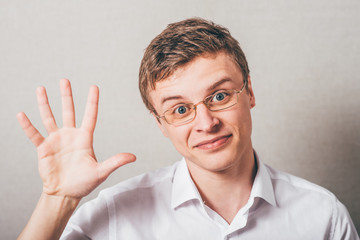 a friendly young man gives five