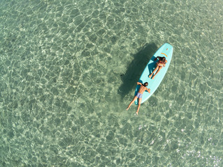 Children on sup board air view