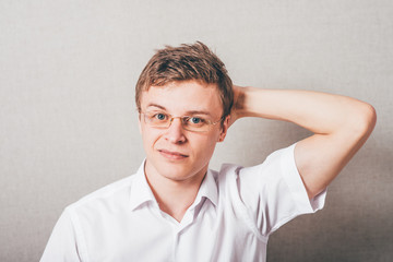 Depressed young business man holding his head