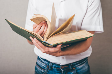 man in glasses reading a big book