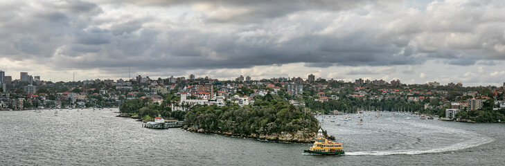 Fototapeta na wymiar Panoramic view of the Mosman bay wharf and Cremorne Point under a dramatic cloudy sky in Sydney, Australia.