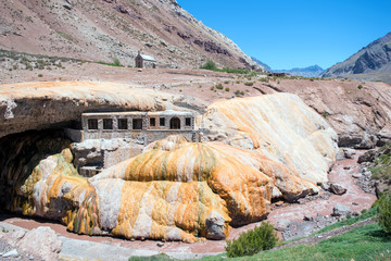 Rock formation in the desert and an old building on it