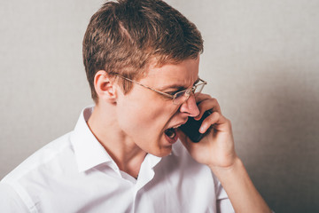 An angry businessman over the phone. - 340030252