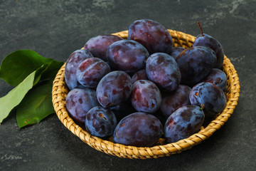 Ripe plum heap in the basket