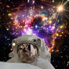 Astronaut and galaxy on the backdrop. The elements of this image furnished by NASA.